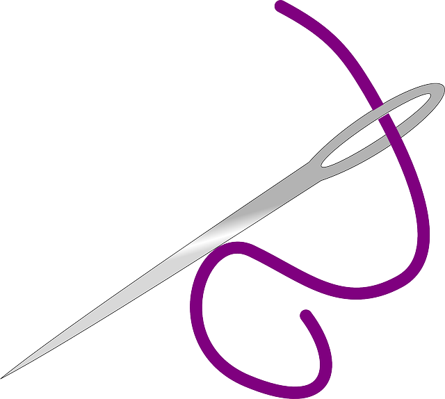 purple thread through a sewing needle